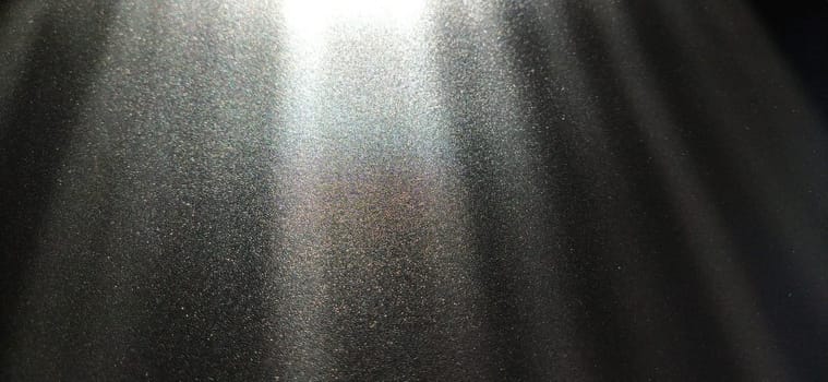 Light beam on black background with sparkles, radiance and sparkles. Festive background. Divine or moonlight effect. Rays falling from top to bottom. The spotlight is shining.
