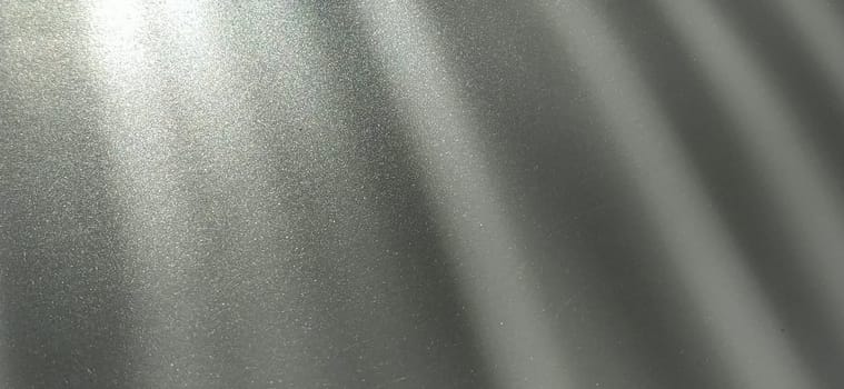 Gray striped background with oblique light effect. Play of light and shadow. Light rays. Gray and silver shades with white dots and shining stars. Diagonal lines from left to right.