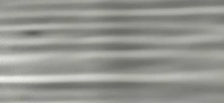 blurred horizontally striped gray background. Play of light and shadow. Light beams. Gray and silver shades with white dots and shining stars
