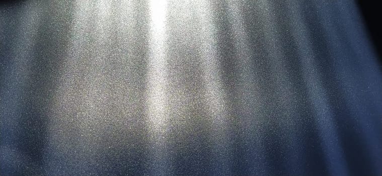 blurred striped dark black and blue background. Play of light and shadow. Light rays. Divine or heavenly radiance from above. Simulate lighting something from above with spotlights. Copy space.