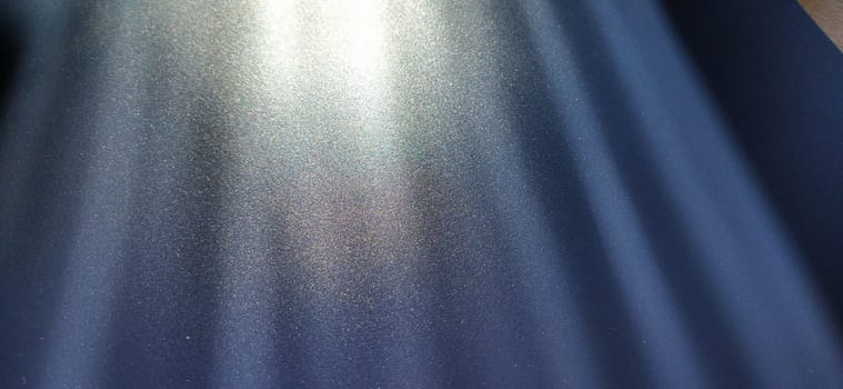 blurred striped dark black and blue background. Play of light and shadow. Light rays. Divine or heavenly radiance from above. Simulate lighting something from above with spotlights. Copy space.