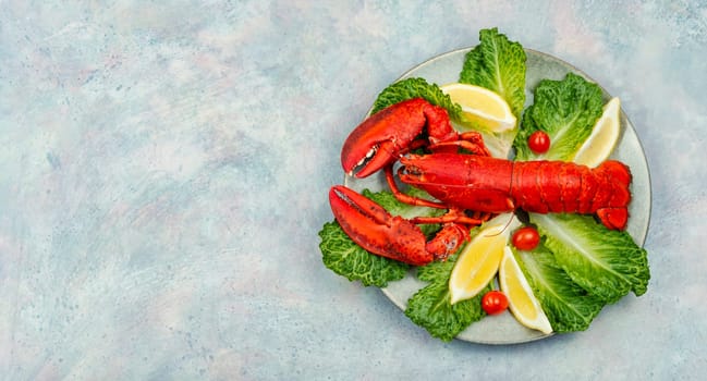 Boiled lobster with lettuce and lemon on a plate. Seafood, copy space
