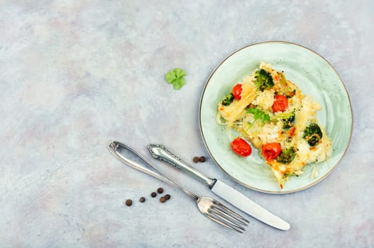 Diet potato casserole with broccoli and tomatoes. Vegetarian food. Food background