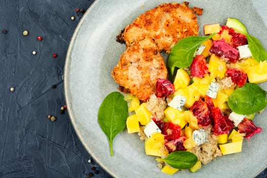 Salad with fruit, chicken breast and quinoa. Fruits salad with meat. Close up
