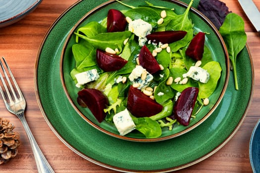 Tasty salad with beets, blue cheese, herbs and pine nuts.
