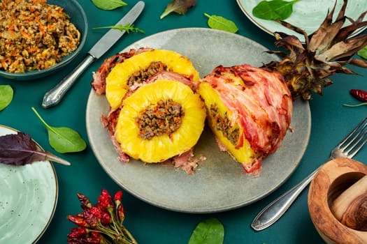 Baked pineapple stuffed with ground beef in bacon wrapped Chinese style