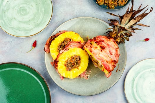 Baked pineapple stuffed with ground beef in bacon wrapped Chinese style
