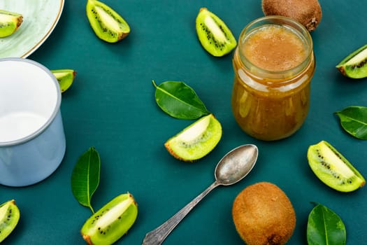 Delicious kiwi jam in a glass jar, space for text
