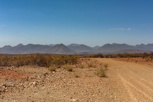 The dusty gravel road along the Kunene River in northern Namibia