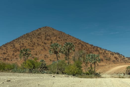The dusty gravel road along the Kunene River in northern Namibia