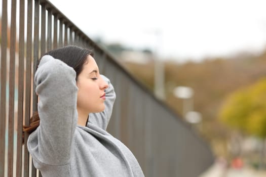 Profile of a woman resting and relaxing in the street