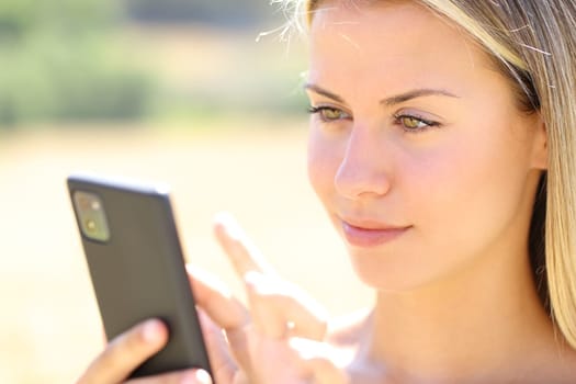 Woman using smart phone in nature