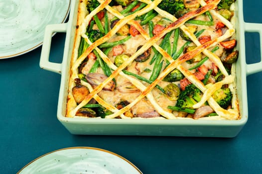 Savoury meat pie with brussels sprouts, pumpkin and broccoli. Autumn recipe.