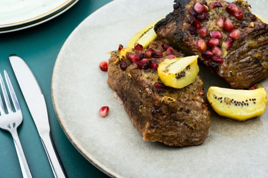 Veal meat roasted in fruit sauce. Top view