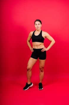 Cool female fighter in boxing bandages trains in a studio. Mixed martial arts.