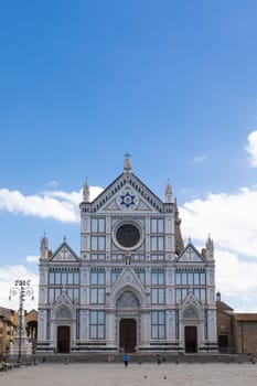 Florence, Italy - June 2022: Basilica of Santa Croce, blue sky and clouds