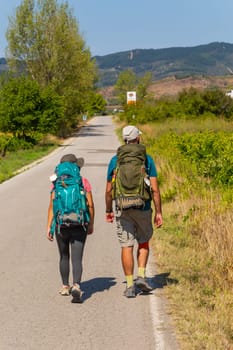 Navarre, Spain, 26 August, 2022: Pilgrims walk along the Camino De Santiago, the Way of St. James pilgrimage route, Navarra, Spain.