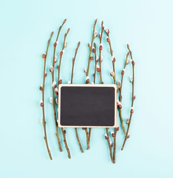 Willow branches with a chalkboard easter holiday greeting card, spring season background