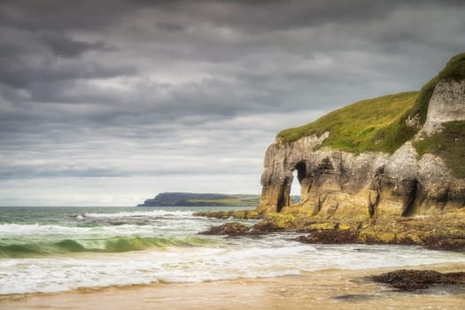Crashing waves and limestone rock formations on White Rocks Beach, Causeway Coast, Wild Atlantic Way, County Antrim, Northern Ireland
