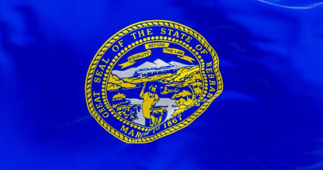 close-up of the Nebraska state flag fluttering. The flag of is blue with the state seal in the center. 3D illustration render. Close-up. Textured fabric background