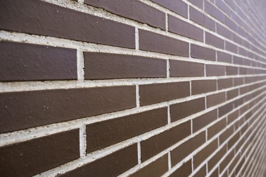 Detail of smooth red brick facade, construction and exterior architecture