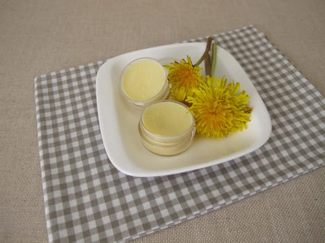 Homemade dandelion ointment, salve with an oil extract of dandelion flowers