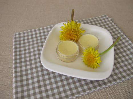 Homemade dandelion ointment, salve with an oil extract of dandelion flowers