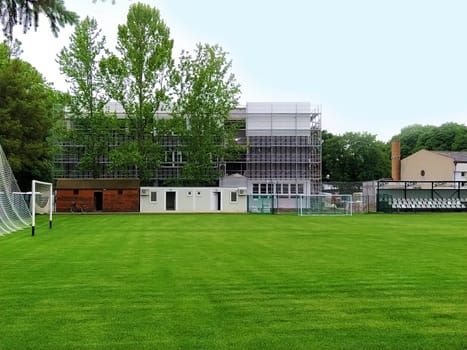 Sremska Mitrovica, Serbia. May 30, 2020. Construction of a new school. School building in scaffolding. Soccer field on the school grounds. Facade work at the final stage of construction.