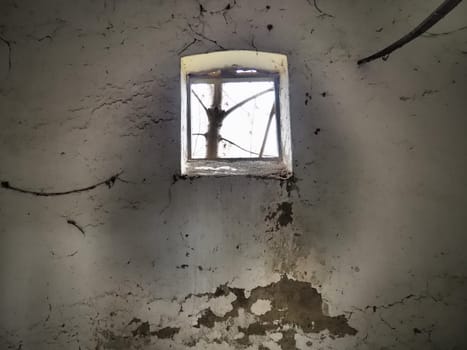 Scary walls with cobwebs. Old church dormer. A small window at the top of the wall. Halloween or haunted place. Prison cell with torture ropes. Visions and a world of hallucinations