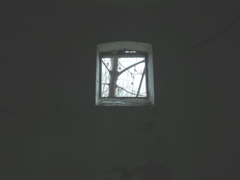 Scary walls with cobwebs. Old church dormer. A small window at the top of the wall. Halloween or haunted place. Prison cell with torture ropes. Visions and a world of hallucinations