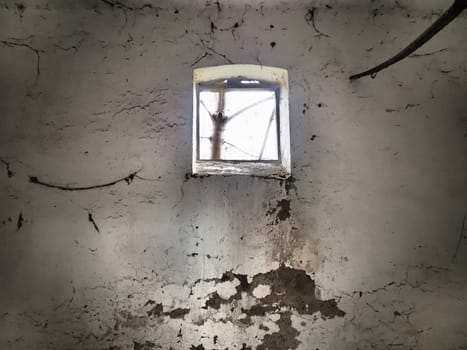 Scary walls with cobwebs. Old church dormer. A small window at the top of the wall. Halloween or haunted place. Prison cell with torture ropes. Visions and a world of hallucinations