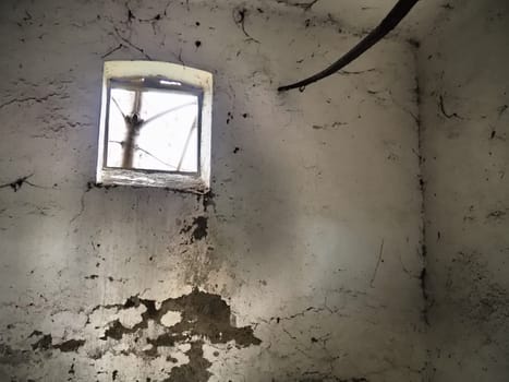 Scary walls with cobwebs. Old church dormer. A small window at the top of the wall. Halloween or haunted place. Prison cell with torture ropes. Visions and a world of hallucinations