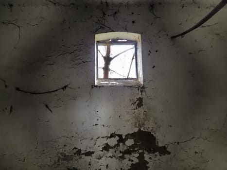 Scary walls with cobwebs. Old church dormer. A small window at the top of the wall. Halloween or haunted place. Prison cell with torture ropes. Visions and a world of hallucinations