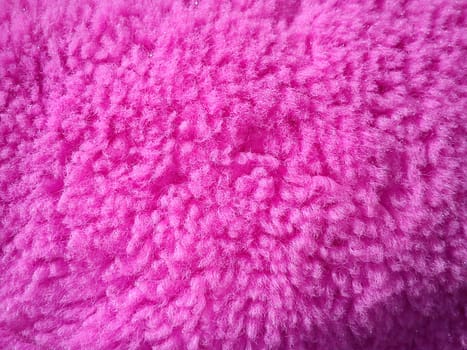 Pink plush material. Wool with spools. Pink Teddy bear