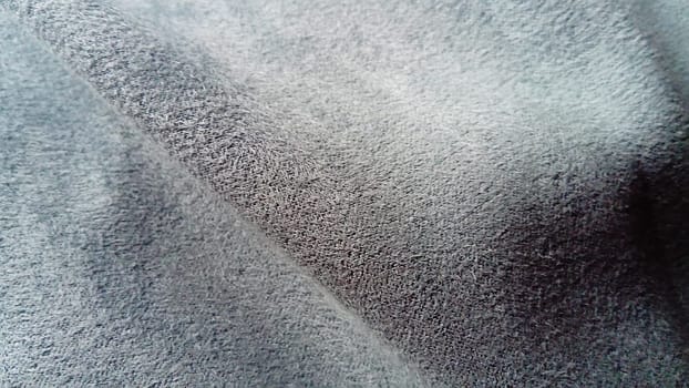 close-up of several waves on a soft velvety fabric of deep gray color