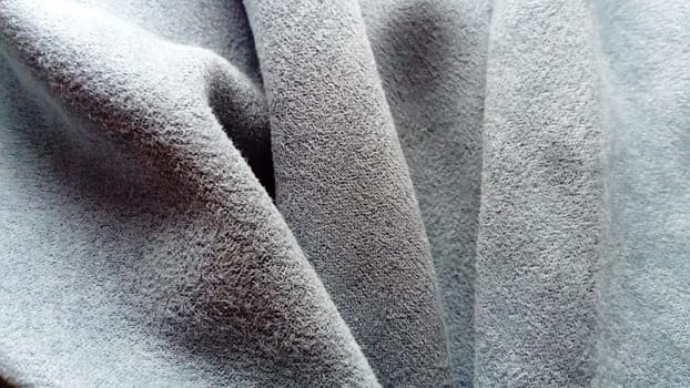 A velvety thick fabric for curtains of gray-blue color