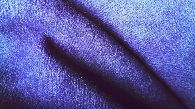 Dark blue fabric that looks like velvet or velveteen. Broken blue and violet waves