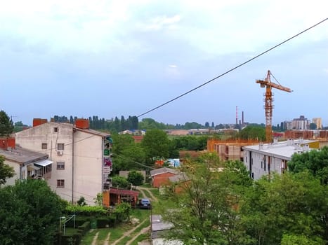 Sremska Mitrovica, Serbia. June 20, 2020. Construction of an apartment building for refugees, police officers, the Ministry of Justice and the military. Lifting crane