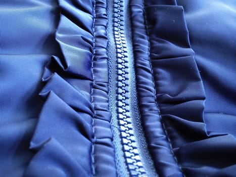 Buttoned sewing lock and decorative fabric trim around. Nice silky blue polyester fabric.