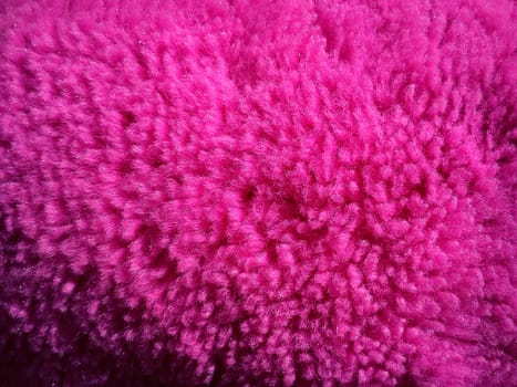 Faux fur or wool of bright pink and fuchsia color. Intense shade. Soft fluffy material for sewing toys, clothes or upholstery. Synthetic fibers. Light falls on the side. Long pile.
