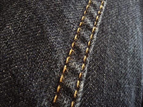double stitch made with yellow threads on black denim.
