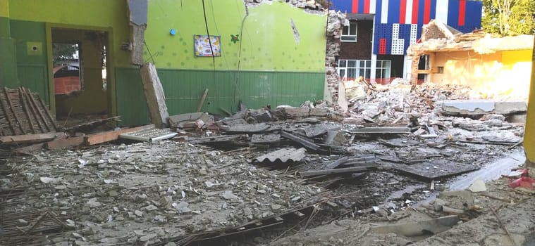 Sremska Mitrovica, Serbia, 13 August 2020. Dismantling and demolition of the old school named after Jovan Popovic. Pieces of concrete, rebar are hanging. Bulldozers are breaking down walls