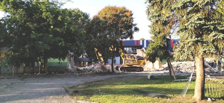 Sremska Mitrovica, Serbia, 13 August 2020. Dismantling and demolition of the old school named after Jovan Popovic. Pieces of concrete, rebar are hanging. Bulldozers are breaking down walls