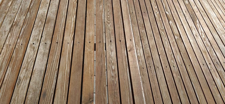 Beautiful smooth unpainted hammered boards. Wooden surface with cracks. A platform or staircase made of wood. Joiner's and carpentry product. The texture of natural material