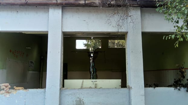 Sremska Mitrovica, Serbia, 13 August 2020. Dismantling and demolition of the old school named after Jovan Popovic. Holes in the walls and ceiling. Ruined classroom.