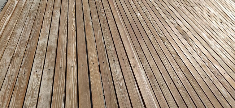 Beautiful smooth unpainted hammered boards. Wooden surface with cracks. A platform or staircase made of wood. Joiner's and carpentry product. The texture of natural material