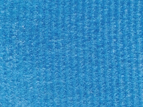 Close-up of a striped fabric with raised printing. Vertical stripes on blue microfiber or sponge.