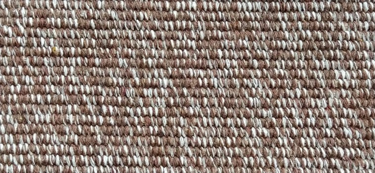 close up of fabric texture for background. Woven coarse cotton fabric with white, beige and brown threads. Banner.