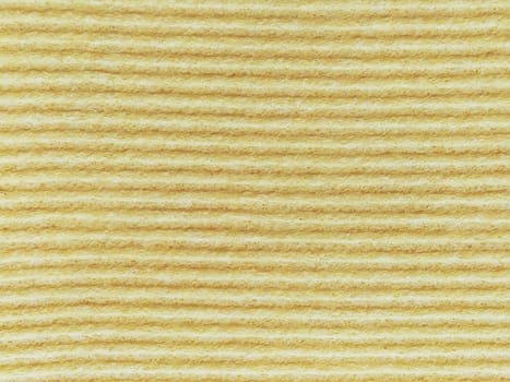 Close-up of a striped fabric with raised printing. Horizontal stripes on yellow microfiber or sponge