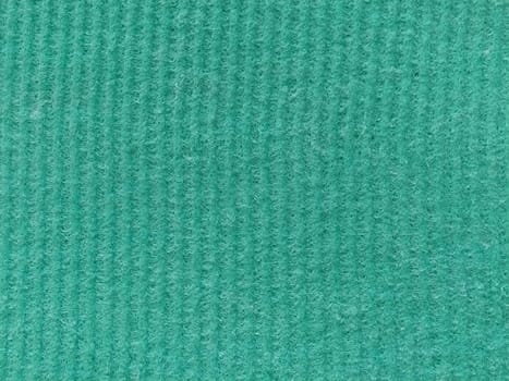 Close-up of a striped fabric with raised printing. Vertical stripes on green microfiber or sponge.